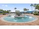 Circular spa with tiled deck and landscaping at 15724 Aurora Lake Cir, Wimauma, FL 33598