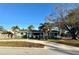 Ranch-style home with a green exterior, palm trees, and a spacious yard at 1599 Arizona Ne Ave, St Petersburg, FL 33703