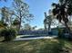 Relaxing kidney shaped pool, surrounded by trees and grass at 1599 Arizona Ne Ave, St Petersburg, FL 33703