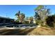 Kidney-shaped pool in a backyard setting with surrounding lawn at 1599 Arizona Ne Ave, St Petersburg, FL 33703