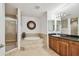 Spa-like bathroom with soaking tub, walk-in shower, and granite vanity at 17717 Gulf Blvd # 601, Redington Shores, FL 33708