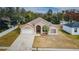 Aerial view of a tan house with a palm tree and driveway at 1833 Hillcrest St, Tarpon Springs, FL 34689