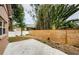 Private backyard with patio, wood fence, and landscaping at 1833 Hillcrest St, Tarpon Springs, FL 34689