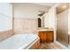 Bathroom featuring a jetted tub, granite vanity, and shower at 1833 Hillcrest St, Tarpon Springs, FL 34689