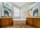 Bathroom with double vanity, corner tub, and granite counters at 1833 Hillcrest St, Tarpon Springs, FL 34689