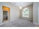 Dining room with carpet, large window, and bathroom access at 1833 Hillcrest St, Tarpon Springs, FL 34689