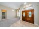 Bright and spacious entryway with double doors, tile flooring and chandelier at 1833 Hillcrest St, Tarpon Springs, FL 34689