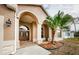 Double-door entry with arched entryway and tile flooring at 1833 Hillcrest St, Tarpon Springs, FL 34689