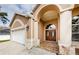 House exterior with double doors and a two-car garage at 1833 Hillcrest St, Tarpon Springs, FL 34689