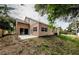 House exterior showcasing a patio and backyard view at 1833 Hillcrest St, Tarpon Springs, FL 34689