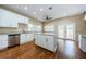 Eat-in kitchen with white cabinets, granite island, and patio access at 1833 Hillcrest St, Tarpon Springs, FL 34689