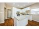 Spacious kitchen with island, granite counters, and white cabinets at 1833 Hillcrest St, Tarpon Springs, FL 34689
