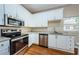 Well-equipped kitchen with stainless steel appliances and white cabinets at 1833 Hillcrest St, Tarpon Springs, FL 34689