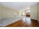 Large living area with carpeted and hardwood floors, showcasing an open floor plan at 1833 Hillcrest St, Tarpon Springs, FL 34689