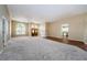Open living room with hardwood and carpeted floors, showing access to kitchen at 1833 Hillcrest St, Tarpon Springs, FL 34689