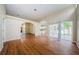 Open living space with hardwood floors, kitchen and patio access at 1833 Hillcrest St, Tarpon Springs, FL 34689