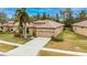 One story house with tan roof, two-car garage and nicely landscaped yard at 205 Silver Falls Dr, Apollo Beach, FL 33572
