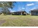 Home with screened lanai and grassy backyard at 205 Silver Falls Dr, Apollo Beach, FL 33572