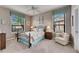 Cozy bedroom with plush carpeting, a comfortable sitting area, and a ceiling fan at 205 Silver Falls Dr, Apollo Beach, FL 33572