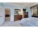 Bedroom with a dresser, TV, and access to a balcony at 205 Silver Falls Dr, Apollo Beach, FL 33572
