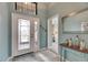 Bright entryway with tile flooring, view to bedroom, and decorative accents at 205 Silver Falls Dr, Apollo Beach, FL 33572