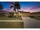 One story house with tan exterior and two-car garage at dusk at 205 Silver Falls Dr, Apollo Beach, FL 33572
