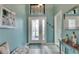 Front entry with a teal console table and decorative wall art at 205 Silver Falls Dr, Apollo Beach, FL 33572