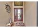 Front entry with a wood bench, decorative lantern, and colorful doormat at 205 Silver Falls Dr, Apollo Beach, FL 33572