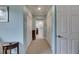 Long hallway with light walls, carpet, and doors to bedrooms and bathroom at 205 Silver Falls Dr, Apollo Beach, FL 33572