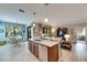 Modern kitchen with an island, stainless steel appliances, and light tile floors at 205 Silver Falls Dr, Apollo Beach, FL 33572