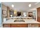 Kitchen island with double sink and breakfast bar overlooking living room at 205 Silver Falls Dr, Apollo Beach, FL 33572
