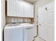 Bright laundry room with washer, dryer, and ample cabinets at 205 Silver Falls Dr, Apollo Beach, FL 33572