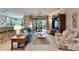 Spacious living area, teal sofa, and view into kitchen and dining area at 205 Silver Falls Dr, Apollo Beach, FL 33572