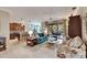 Open living space with teal sofa, wood flooring and access to patio at 205 Silver Falls Dr, Apollo Beach, FL 33572