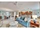 Open living room, teal couch, and view to kitchen and dining area at 205 Silver Falls Dr, Apollo Beach, FL 33572