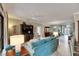 Living area with teal sofa, and views into kitchen and dining room at 205 Silver Falls Dr, Apollo Beach, FL 33572