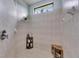 Large walk-in shower with tiled walls and a built-in seat at 205 Silver Falls Dr, Apollo Beach, FL 33572