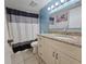 Clean bathroom with granite countertop vanity, shower/tub combo, and updated fixtures at 2067 Hunters Glen Dr # 313, Dunedin, FL 34698