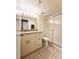 Updated bathroom with granite vanity, large mirror, and a shower at 2067 Hunters Glen Dr # 313, Dunedin, FL 34698