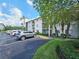 Exterior view of building with parking at 2067 Hunters Glen Dr # 313, Dunedin, FL 34698
