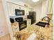Kitchen with granite countertops and black appliances at 2067 Hunters Glen Dr # 313, Dunedin, FL 34698