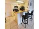 Kitchen with granite countertops and breakfast bar at 2067 Hunters Glen Dr # 313, Dunedin, FL 34698