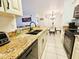 Kitchen with granite countertops and island at 2067 Hunters Glen Dr # 313, Dunedin, FL 34698