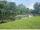 Scenic pond view with lush landscaping at 2067 Hunters Glen Dr # 313, Dunedin, FL 34698