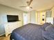 Main bedroom with a king-size bed, dresser, and access to a private bathroom at 2067 Hunters Glen Dr # 313, Dunedin, FL 34698