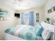 Bedroom with a queen bed, TV and ocean view at 2406 Gulf Blvd # 204, Indian Rocks Beach, FL 33785