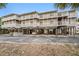 Two-story building with parking underneath and private balconies at 2406 Gulf Blvd # 204, Indian Rocks Beach, FL 33785