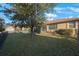Large backyard with a fire pit and lush green grass at 2564 Grand Cypress Blvd, Palm Harbor, FL 34684