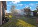 Sunny backyard with a fire pit and a privacy fence at 2564 Grand Cypress Blvd, Palm Harbor, FL 34684