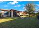 Spacious backyard with a fire pit and screened patio at 2564 Grand Cypress Blvd, Palm Harbor, FL 34684
